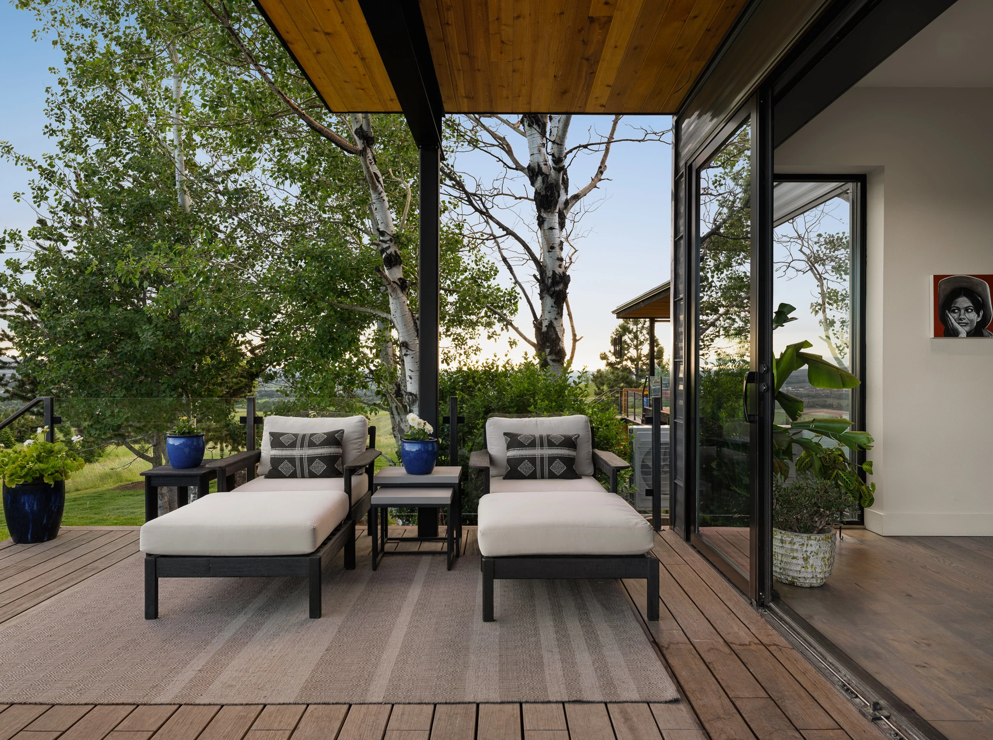 Covered deck with lounge chairs at dusk among the aspens — architectural photography Bozeman Montana, Living Places Design Studio